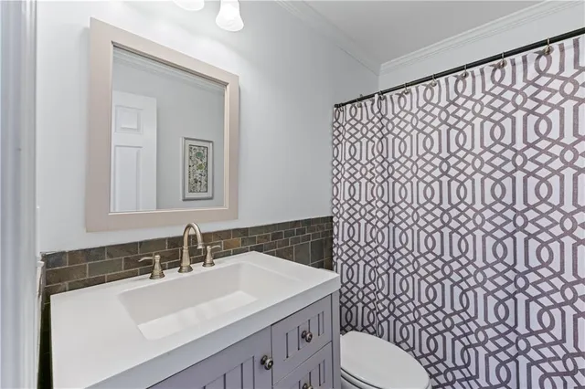 a bathroom with a sink a toilet and mirror