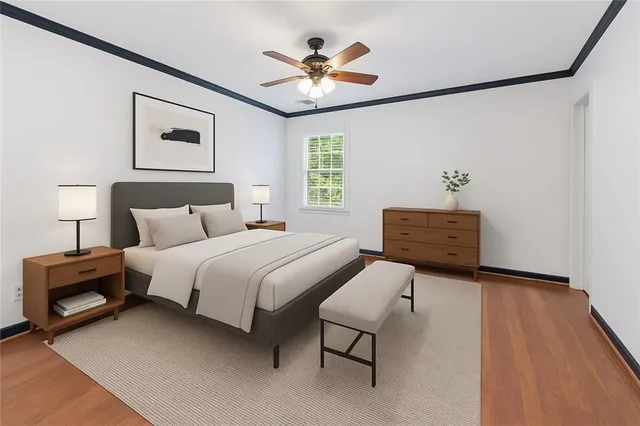 a bedroom with a bed and a ceiling fan