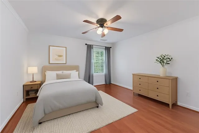 a bedroom with a bed chandelier and a window