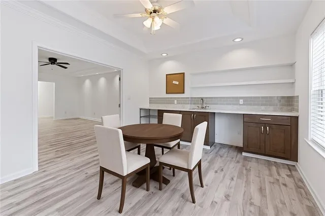 a view of a dining room with furniture and wooden floor
