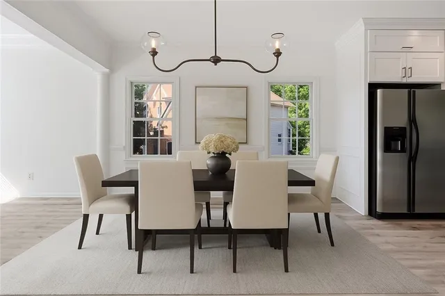 a view of a dining room with furniture window and wooden floor