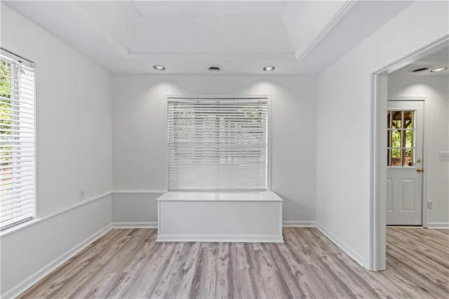 wooden floor in an empty room with a window