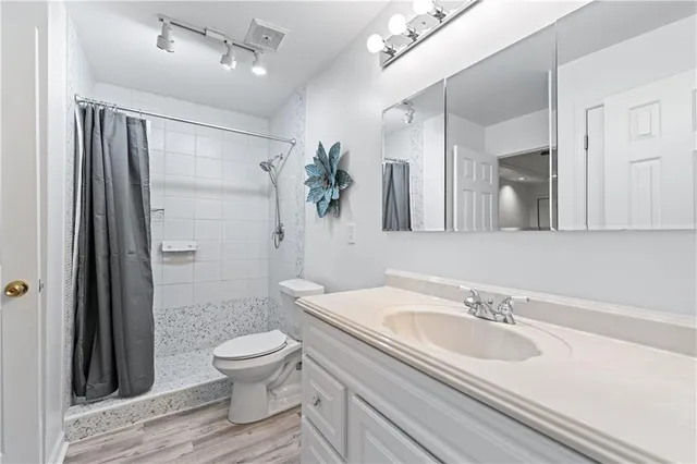 a bathroom with a sink toilet and shower