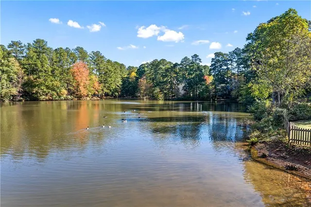 a view of a lake with houses in the back