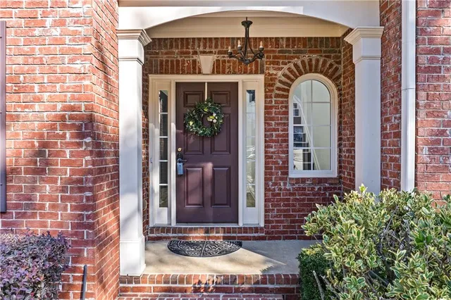 a front view of a house with plants