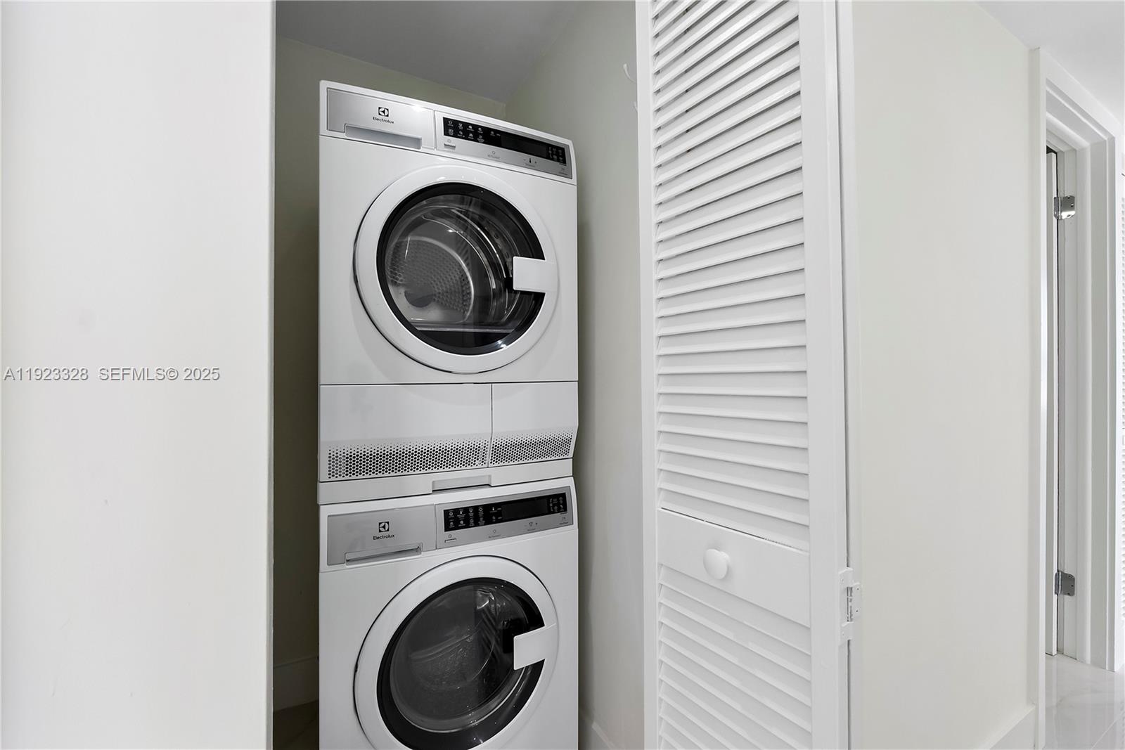 780 Northeast 69th Street, Unit 1601 Miami, FL 33138 - Photo 14 of 18 a view of a hallway with washer and dryer