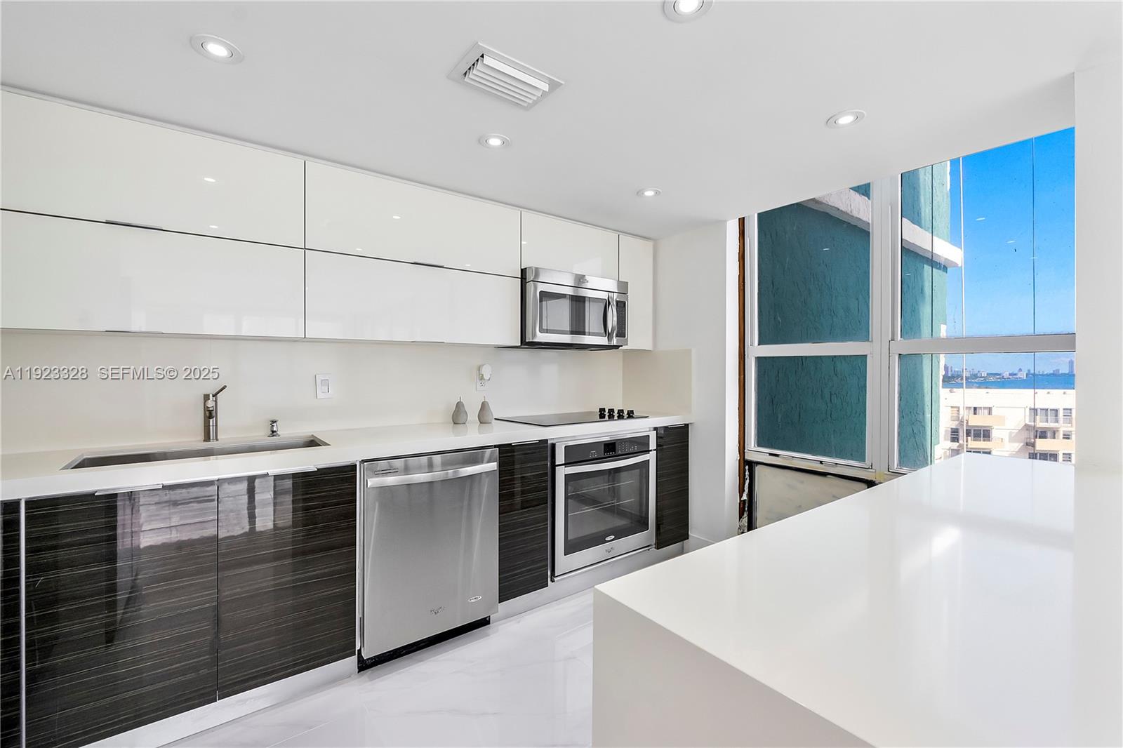 780 Northeast 69th Street, Unit 1601 Miami, FL 33138 - Photo 3 of 18 a kitchen with stainless steel appliances a sink stove and refrigerator