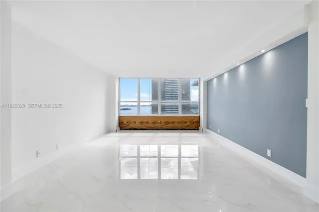 a kitchen with stainless steel appliances granite countertop a stove a sink a refrigerator and a cabinets