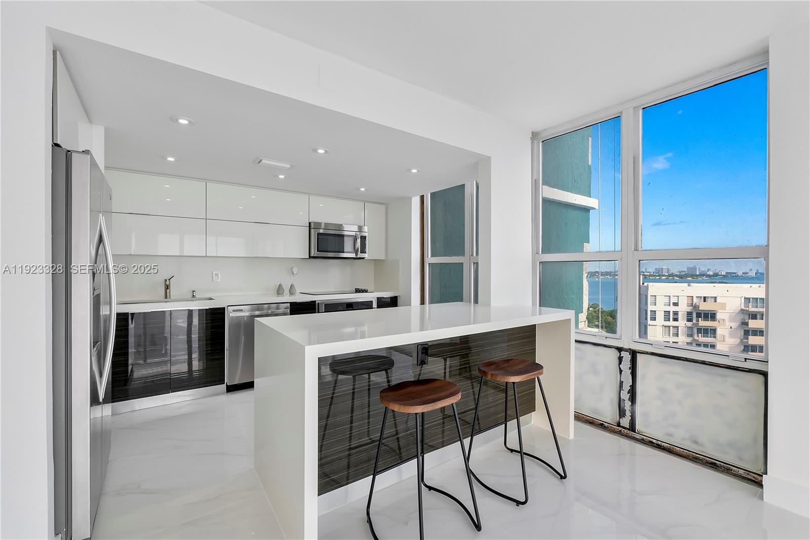 780 Northeast 69th Street, Unit 1601 Miami, FL 33138 - Photo 5 of 18 a kitchen with stainless steel appliances granite countertop a stove a sink a refrigerator and a cabinets