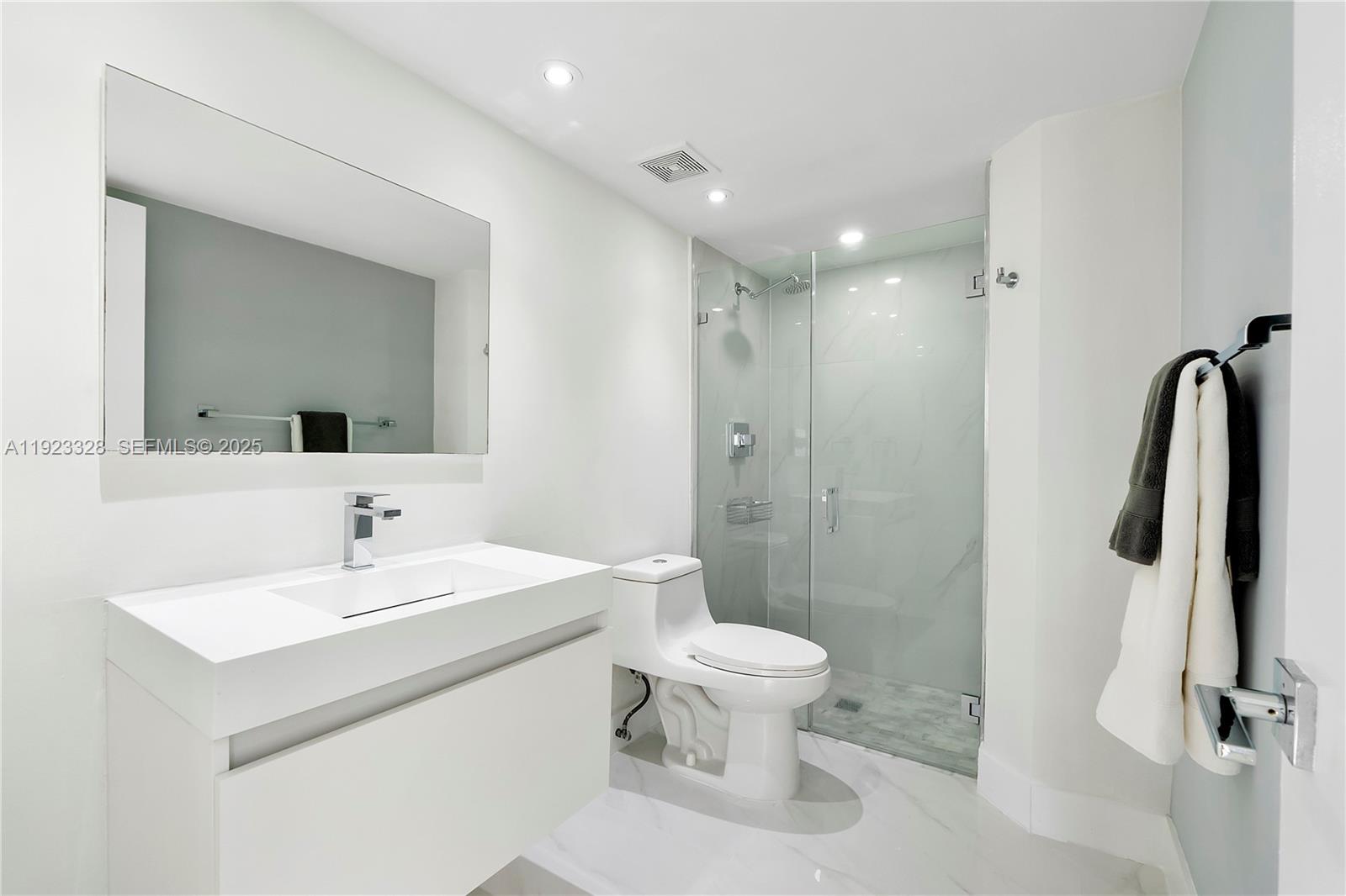 780 Northeast 69th Street, Unit 1601 Miami, FL 33138 - Photo 6 of 18 a bathroom with a sink toilet and shower