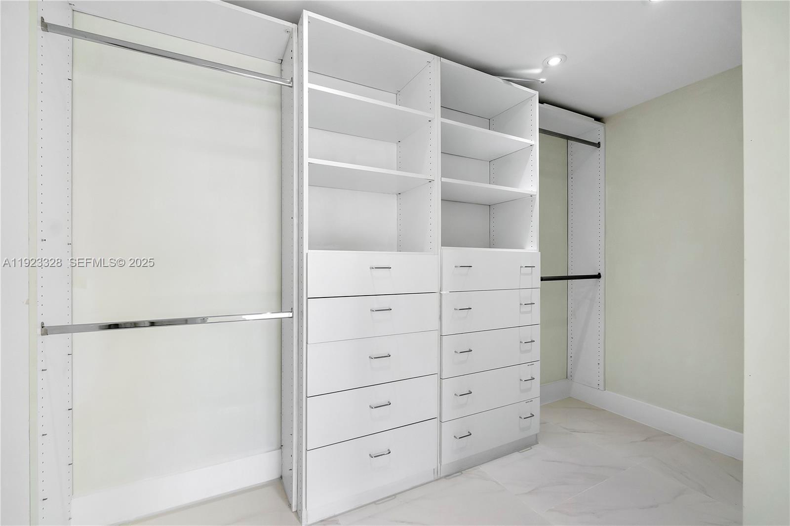 780 Northeast 69th Street, Unit 1601 Miami, FL 33138 - Photo 9 of 18 a view of walk in closet with empty racks