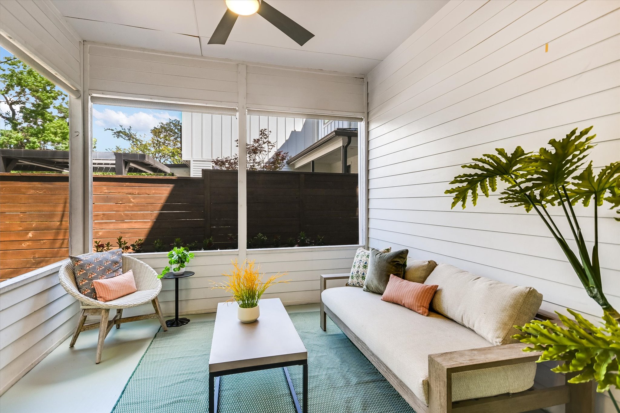 1605 Hether Street Austin, TX 78704 - Photo 13 of 26 Screened porch featuring white horizontal plank siding, a ceiling fan with integrated lighting, and light-toned flooring