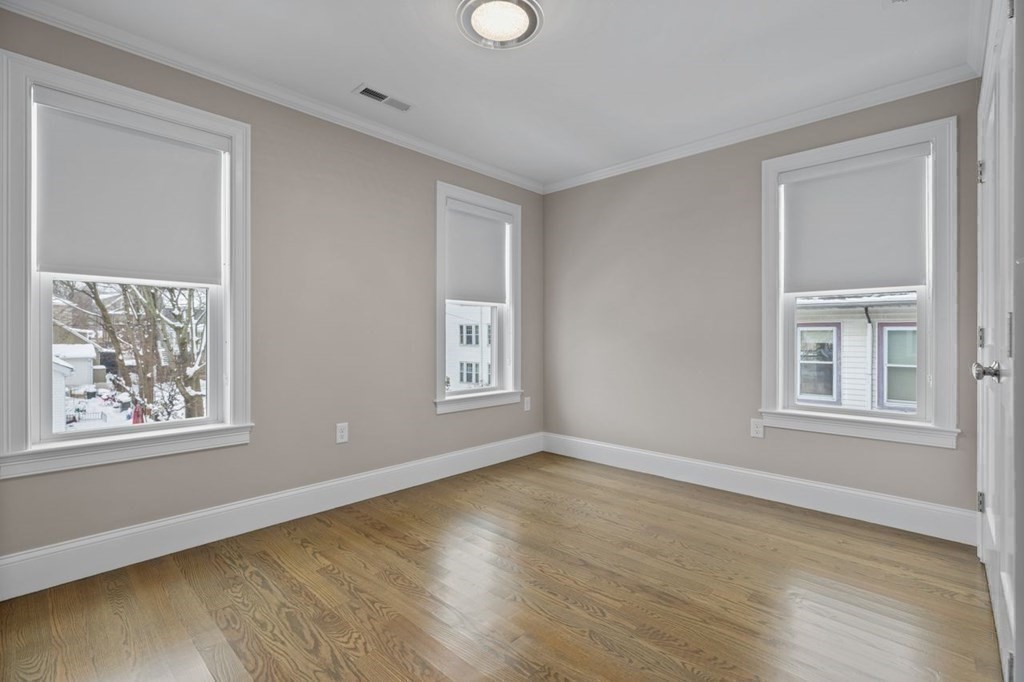 46 Murray Hill Road Boston, MA 02131 - Photo 16 of 25 a view of an empty room with wooden floor and a window