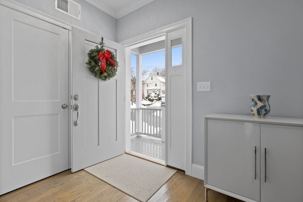 46 Murray Hill Road Boston, MA 02131 - Photo 17 of 25 a view of a hallway with wooden floor and a living room