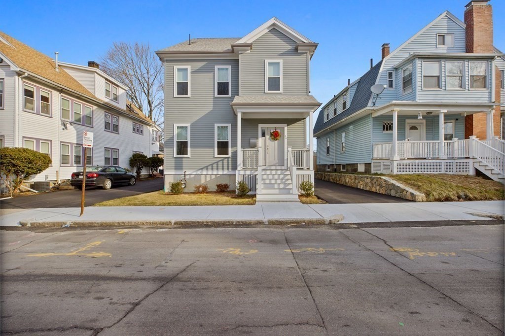 46 Murray Hill Road Boston, MA 02131 - Photo 19 of 25 a view of a white house with a large windows next to a road