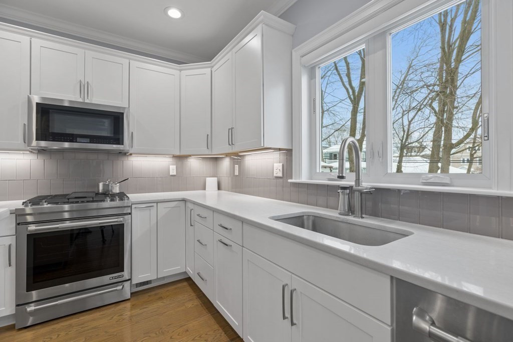 46 Murray Hill Road Boston, MA 02131 - Photo 2 of 25 a kitchen with granite countertop a sink stainless steel appliances a window and a sink