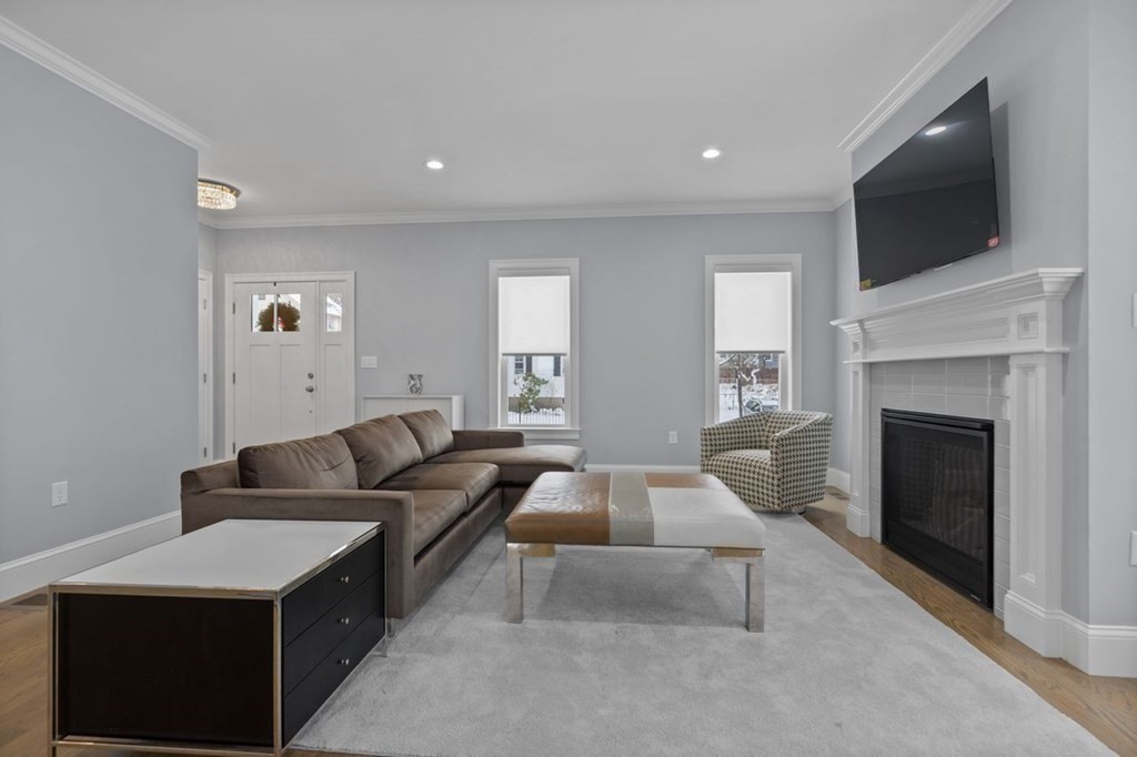 46 Murray Hill Road Boston, MA 02131 - Photo 6 of 25 a living room with furniture a flat screen tv and a fireplace