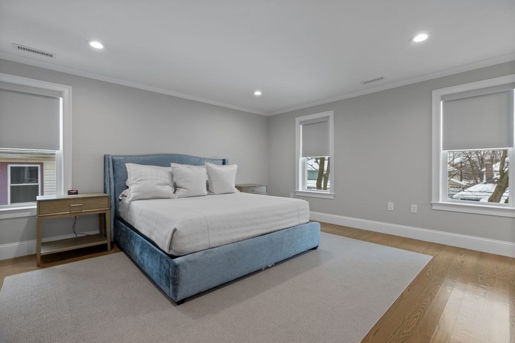 46 Murray Hill Road Boston, MA 02131 - Photo 8 of 25 a spacious bedroom with a bed and cabinet