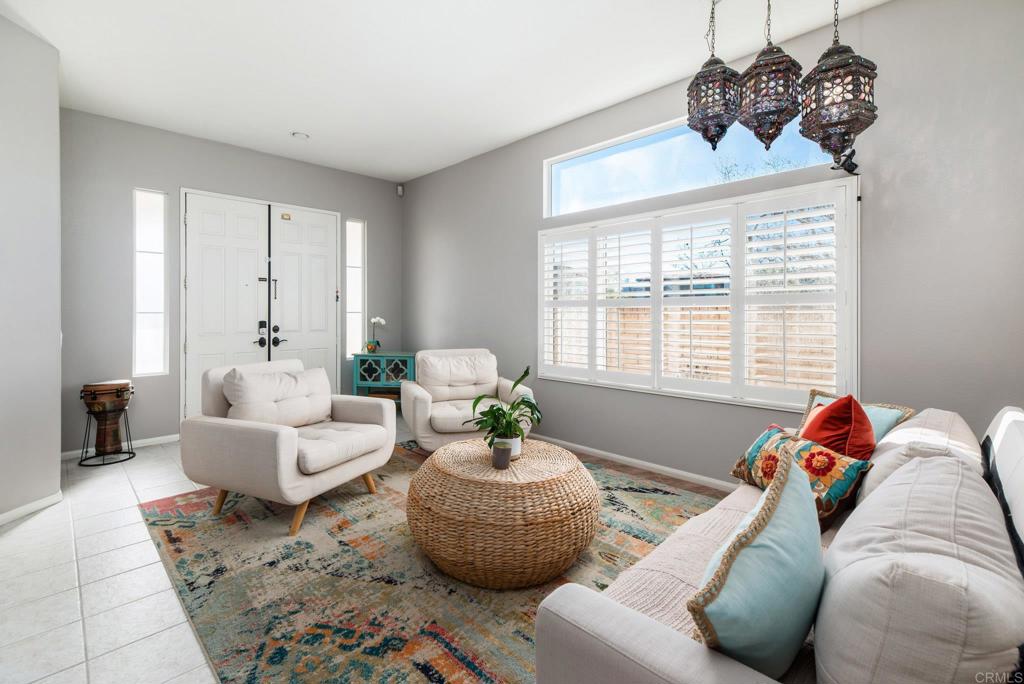 5654 Weatherstone Court San Diego, CA 92130 - Photo 2 of 3 a living room with furniture and a large mirror