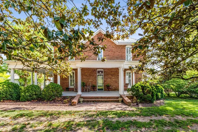 a view of house with yard