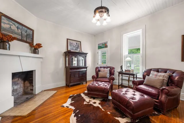 a living room with furniture a fireplace and a window