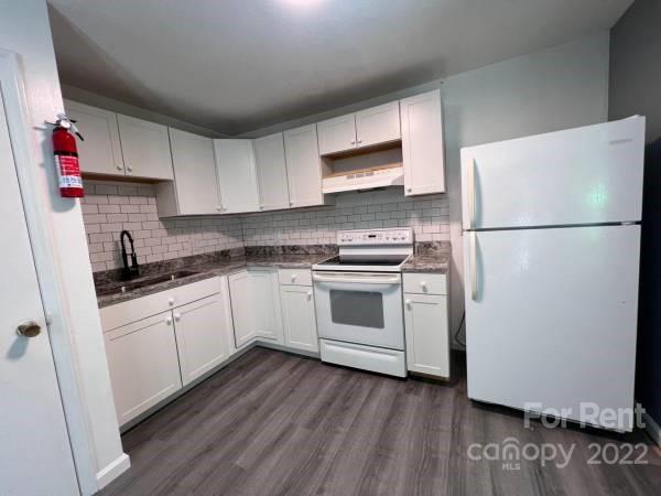 a kitchen with a white cabinets and white appliances