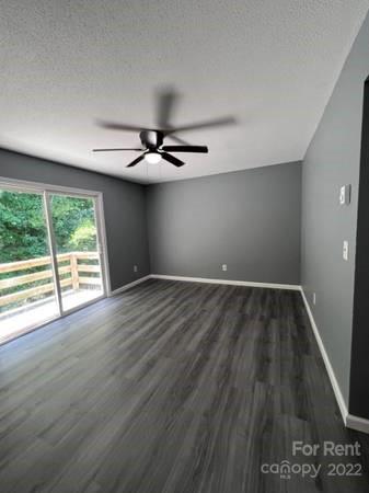 1962 Lakeview Road, Unit A Asheboro, NC 27203 - Photo 13 of 17 a view of an empty room with wooden floor and a window