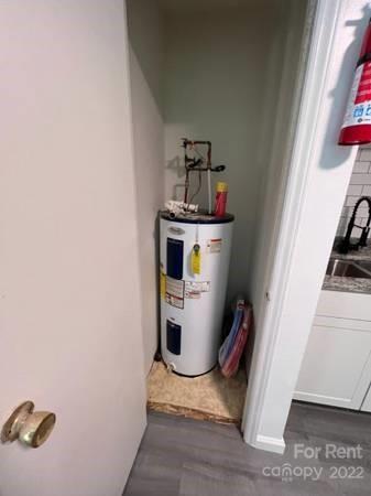 1962 Lakeview Road, Unit A Asheboro, NC 27203 - Photo 15 of 17 a storage room with water heater and racks