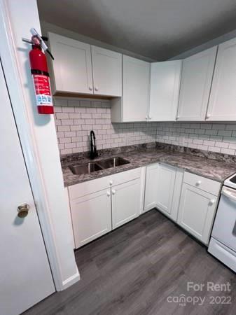 1962 Lakeview Road, Unit A Asheboro, NC 27203 - Photo 16 of 17 a white kitchen with sink and cabinets