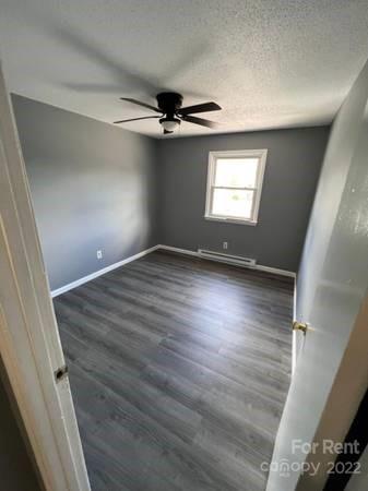 1962 Lakeview Road, Unit A Asheboro, NC 27203 - Photo 2 of 17 wooden floor in an empty room with a window