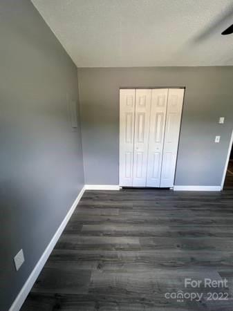 1962 Lakeview Road, Unit A Asheboro, NC 27203 - Photo 9 of 17 a view of an empty room with wooden floor and a window