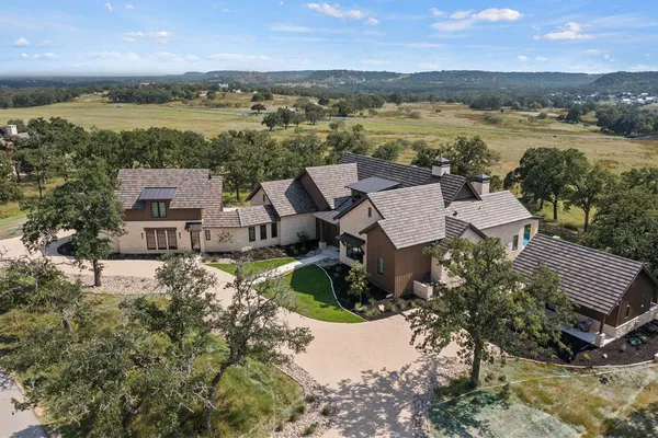 an aerial view of a house with a lake view