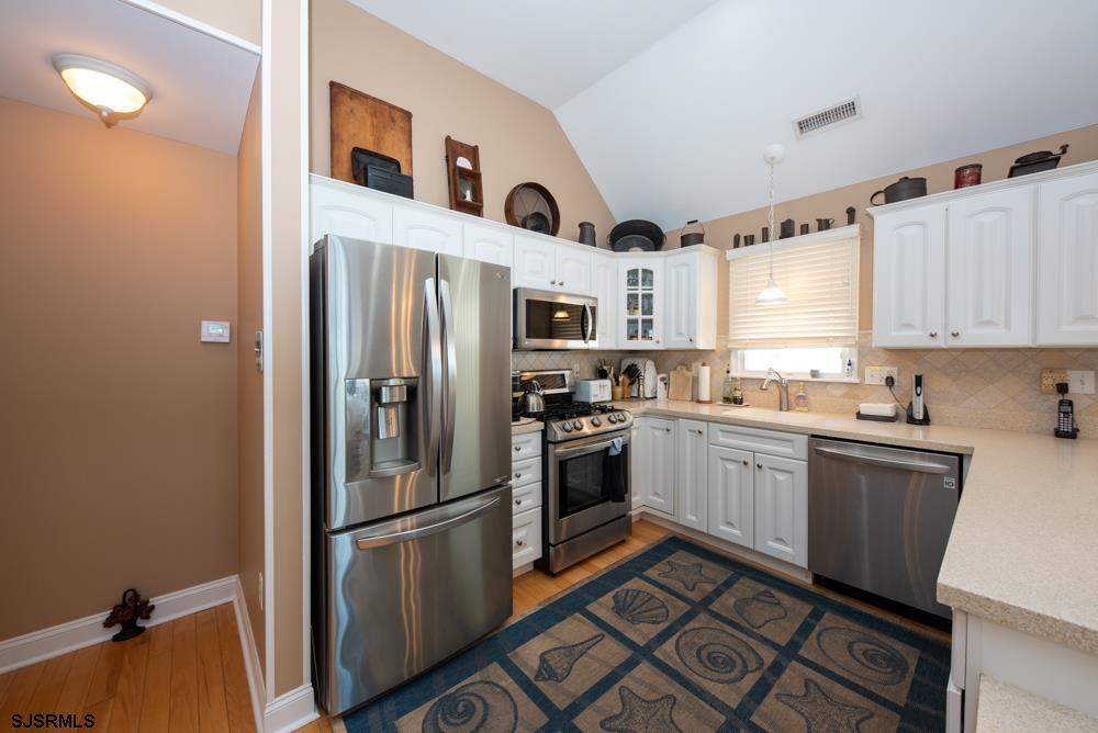 336 West Surf Road Ocean City, NJ 08226 - Photo 14 of 29 a kitchen with stainless steel appliances granite countertop a refrigerator and a stove top oven