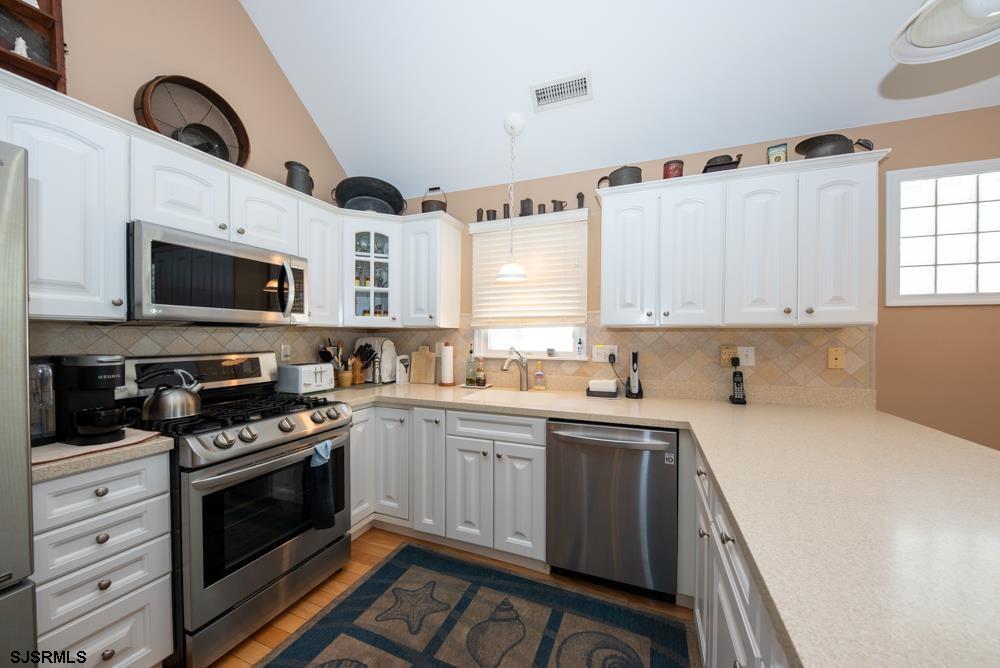 336 West Surf Road Ocean City, NJ 08226 - Photo 15 of 29 a kitchen with granite countertop a sink stainless steel appliances and cabinets