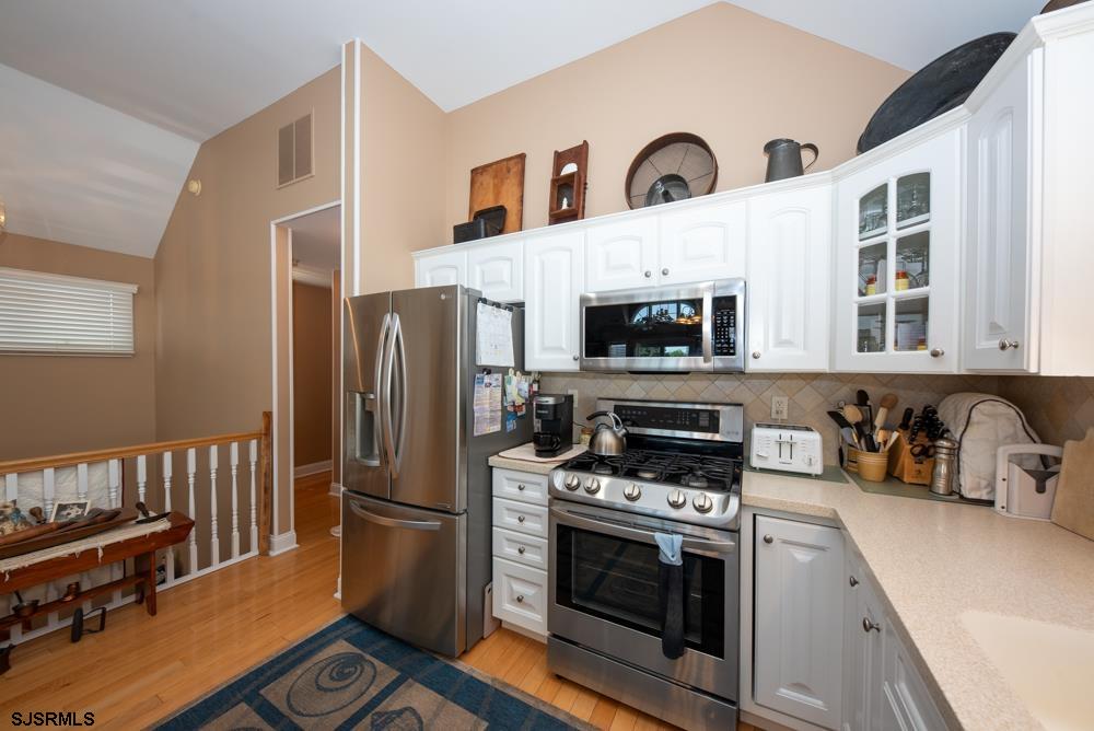 336 West Surf Road Ocean City, NJ 08226 - Photo 16 of 29 a kitchen with stainless steel appliances a stove a sink and a refrigerator