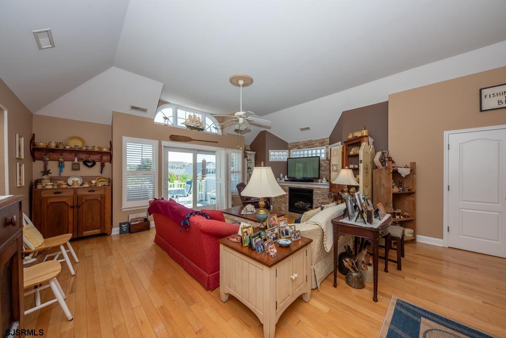 336 West Surf Road Ocean City, NJ 08226 - Photo 17 of 29 a living room with furniture a flat screen tv and a floor to ceiling window