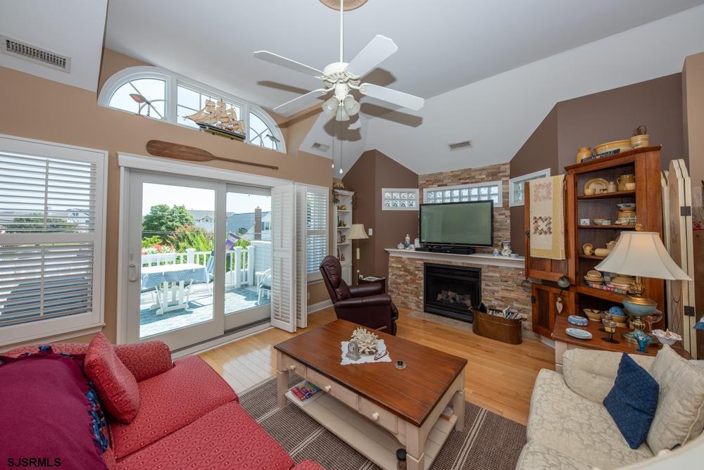 336 West Surf Road Ocean City, NJ 08226 - Photo 18 of 29 a living room with furniture a fireplace and a flat screen tv