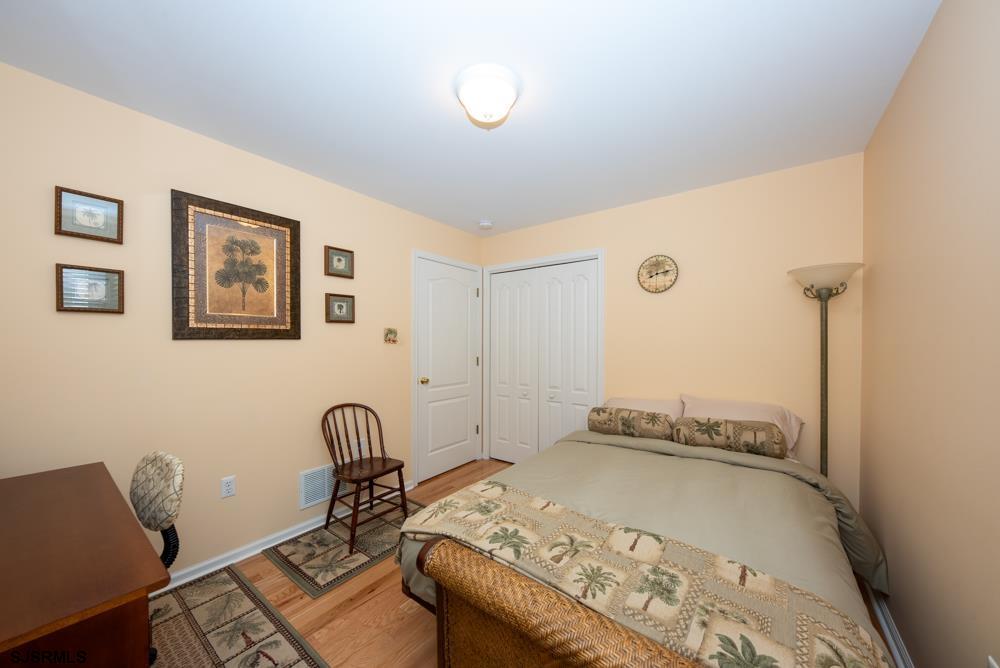 336 West Surf Road Ocean City, NJ 08226 - Photo 7 of 29 a bedroom with a bed and wooden floor