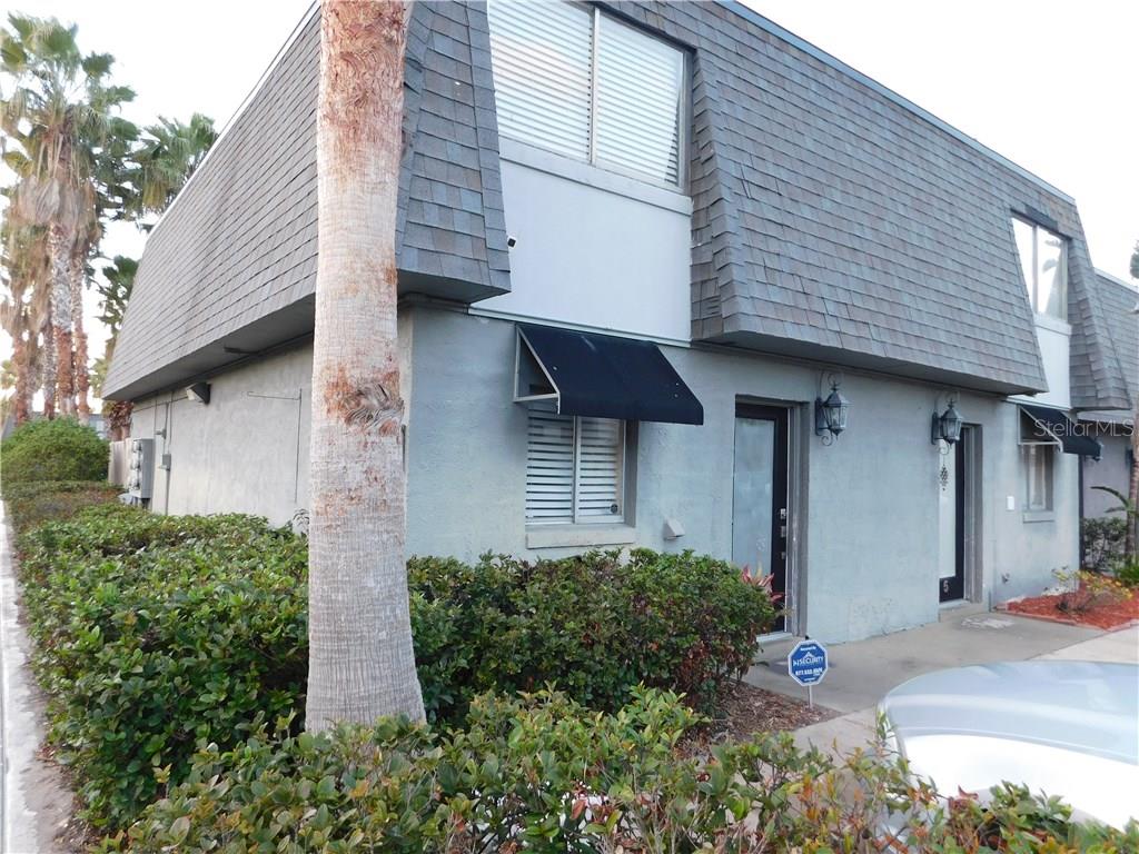 1950 South Conway Road, Unit 6 Orlando, FL 32812 - Photo 1 of 1 a view of a house with large windows and plants