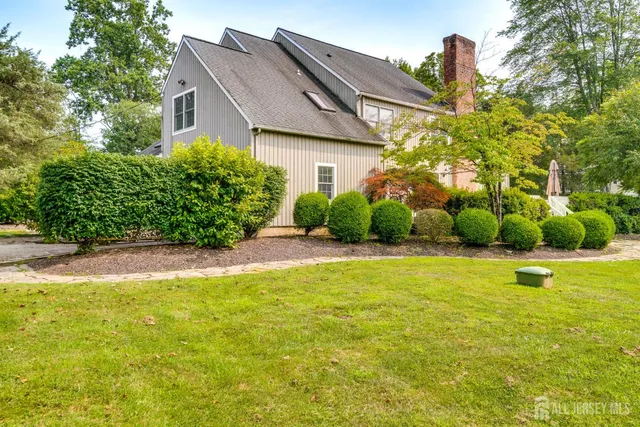 a view of a house with a yard and sitting area