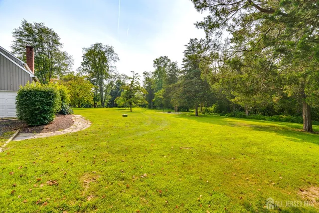 a view of a house with a yard and sitting area