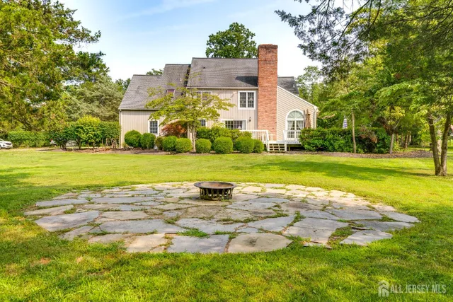 a view of a house with a yard and a house
