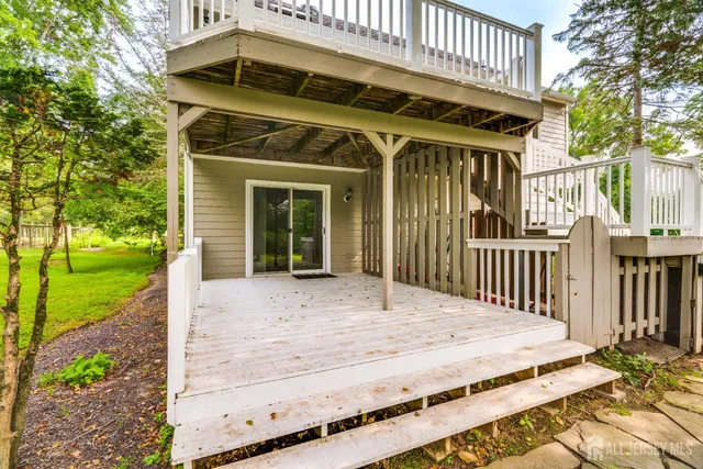 a view of a hallway with wooden floor and stairs