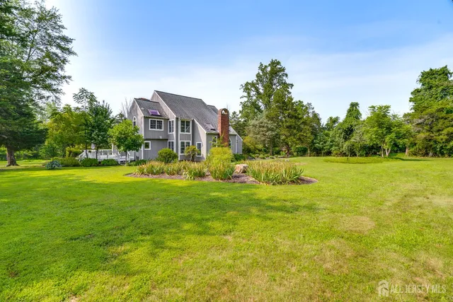 a front view of a house with a yard and trees