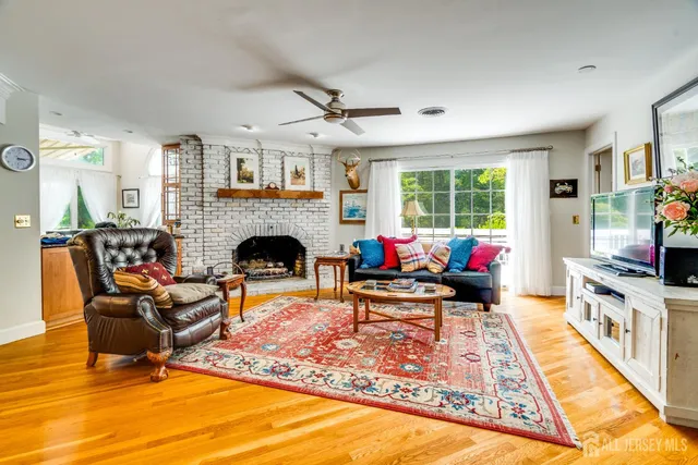 a view of a dining room and hall with furniture and floor to ceiling window