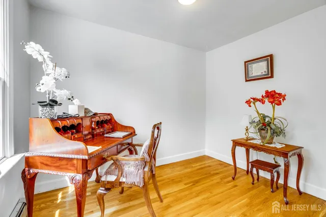 a living room with furniture fireplace and a large window
