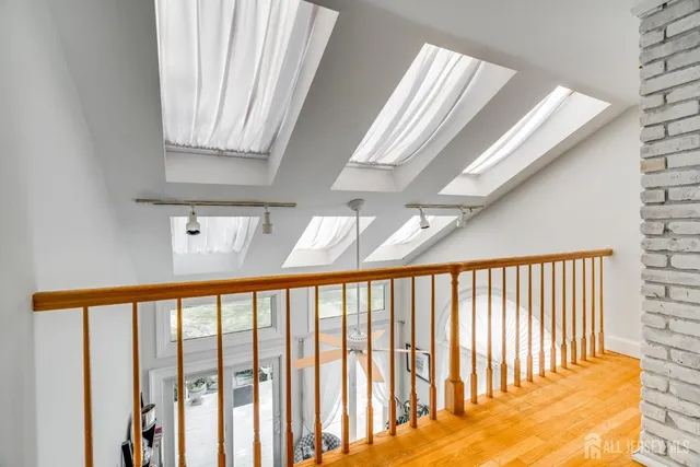 a kitchen with a refrigerator a stove a sink cabinets and wooden floor