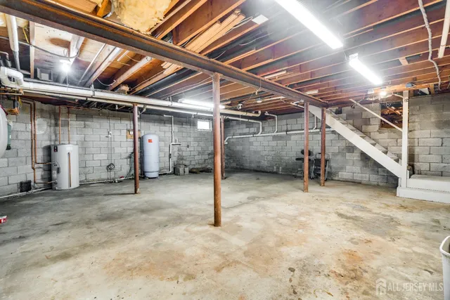 a bathroom with a sink a light fixture and a mirror