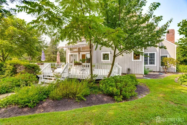 a view of a patio with a table and chairs with wooden floor and fence