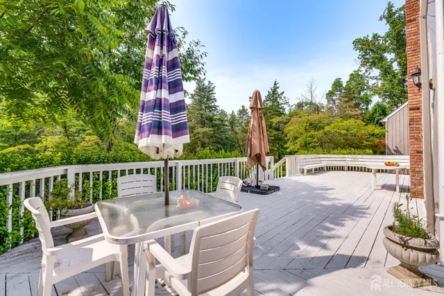 a view of a house with a big yard and palm trees